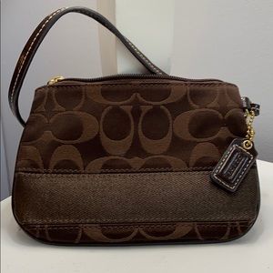 Small Coach wristlet purse with zipper.